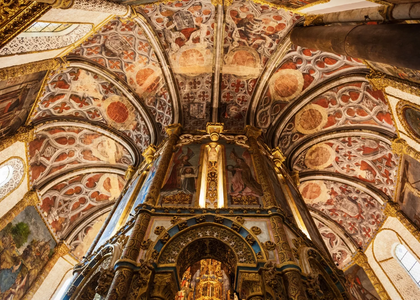 Interior view of the Charola in the Convent of Christ, Tomar, Portugal, showcasing its richly decorated vaults and frescoes.