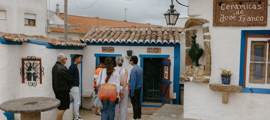 Visitors standing in front of the miniature houses at José Franco’s traditional village in Mafra, Portugal