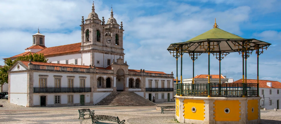 Bandstand and Sanctuary of Our Lady of Nazaré at Praça da República, Portugal, on a sunny day.