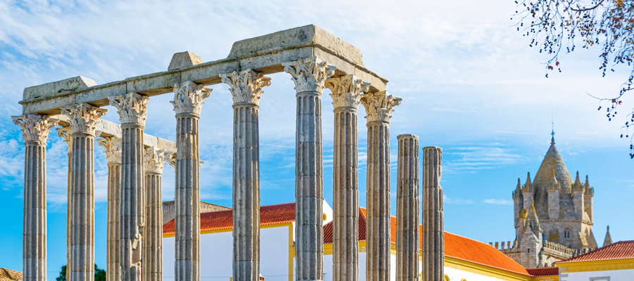 View of the Roman Temple of Évora in Portugal, with its Corinthian columns and the Cathedral of Évora in the background.