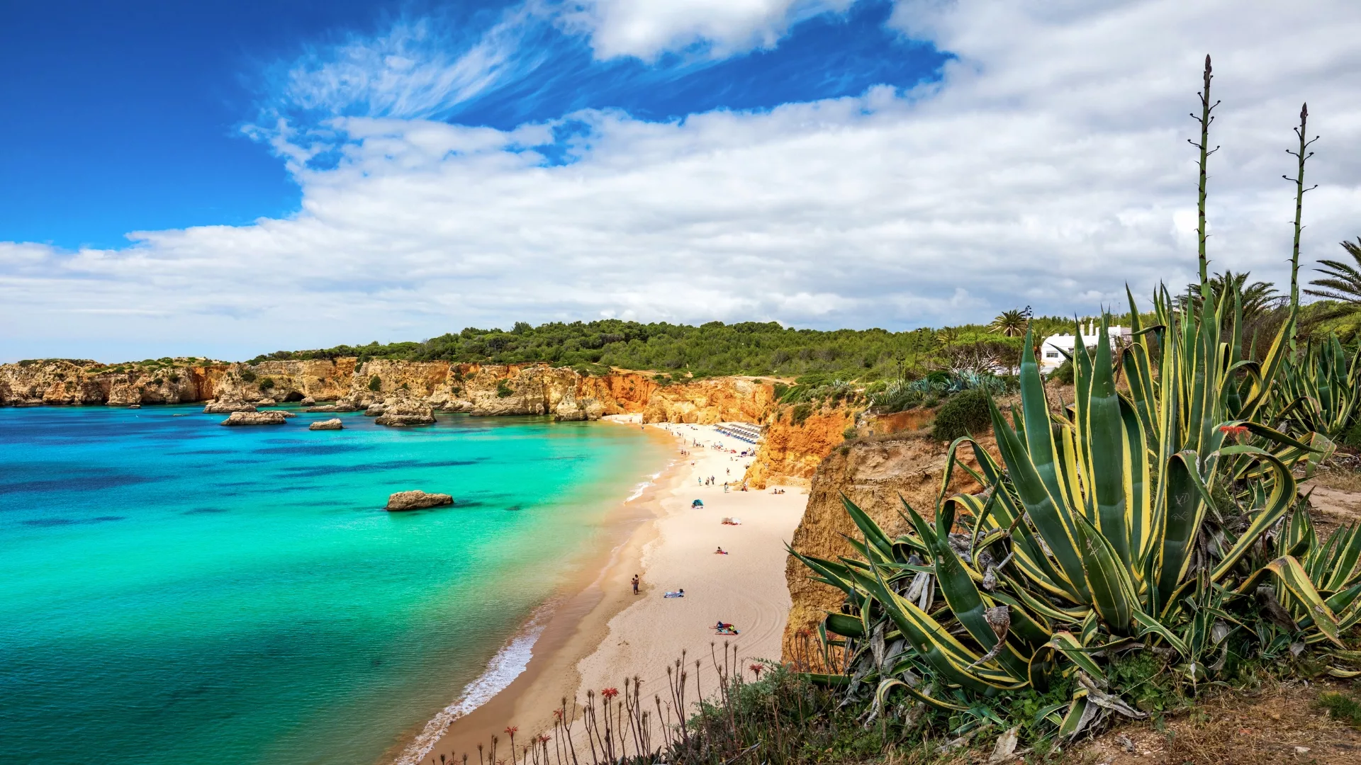 Secluded Praia do Barranco beach in Portugal, surrounded by cliffs and crystal-clear waters