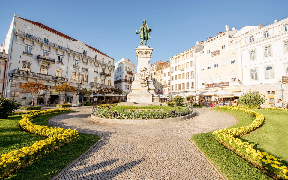 Statue of Joaquim António de Aguiar in Praça 8 de Maio, a historic square in Coimbra, Portugal, facing the Church of Santa Cruz.