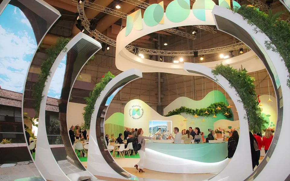 Modern and sustainable-themed Madeira tourism stand at Lisbon Travel Market (BTL), featuring circular green structures and interactive spaces.
