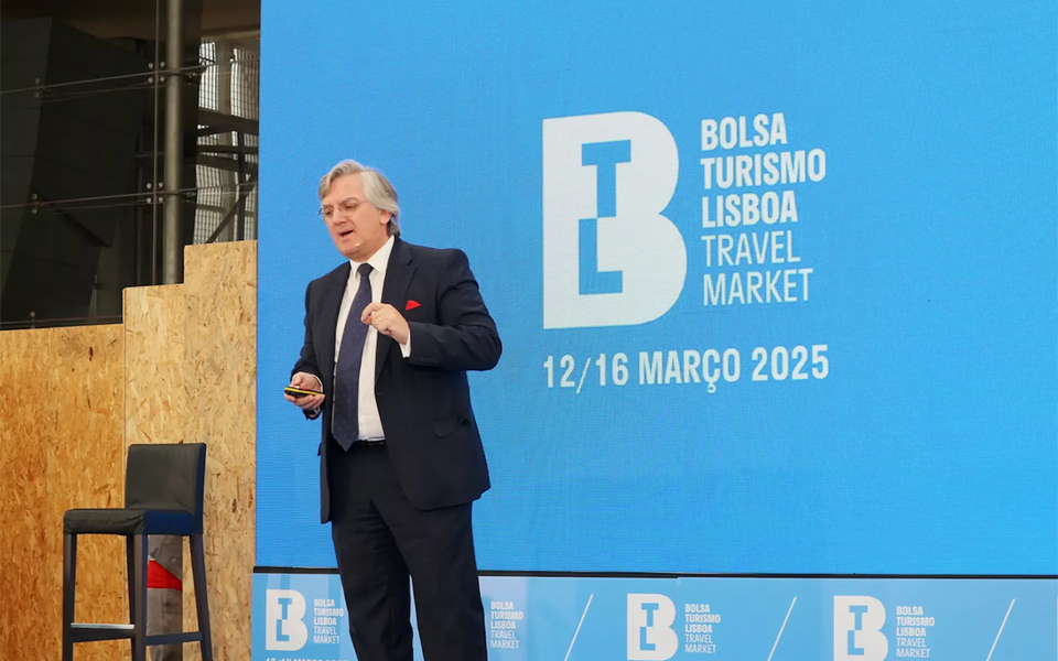Pedro Braga speaking at BTL Lisbon Travel Market 2025 launch event, with event logo and dates displayed on a large blue screen