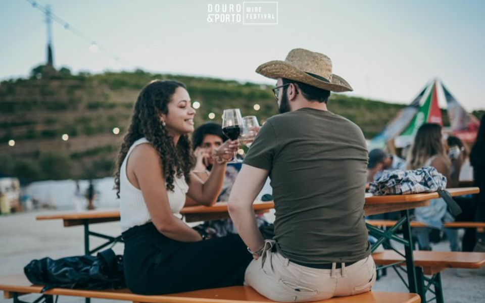 Couple enjoying a toast with red wine at the Douro & Porto Wine Festival