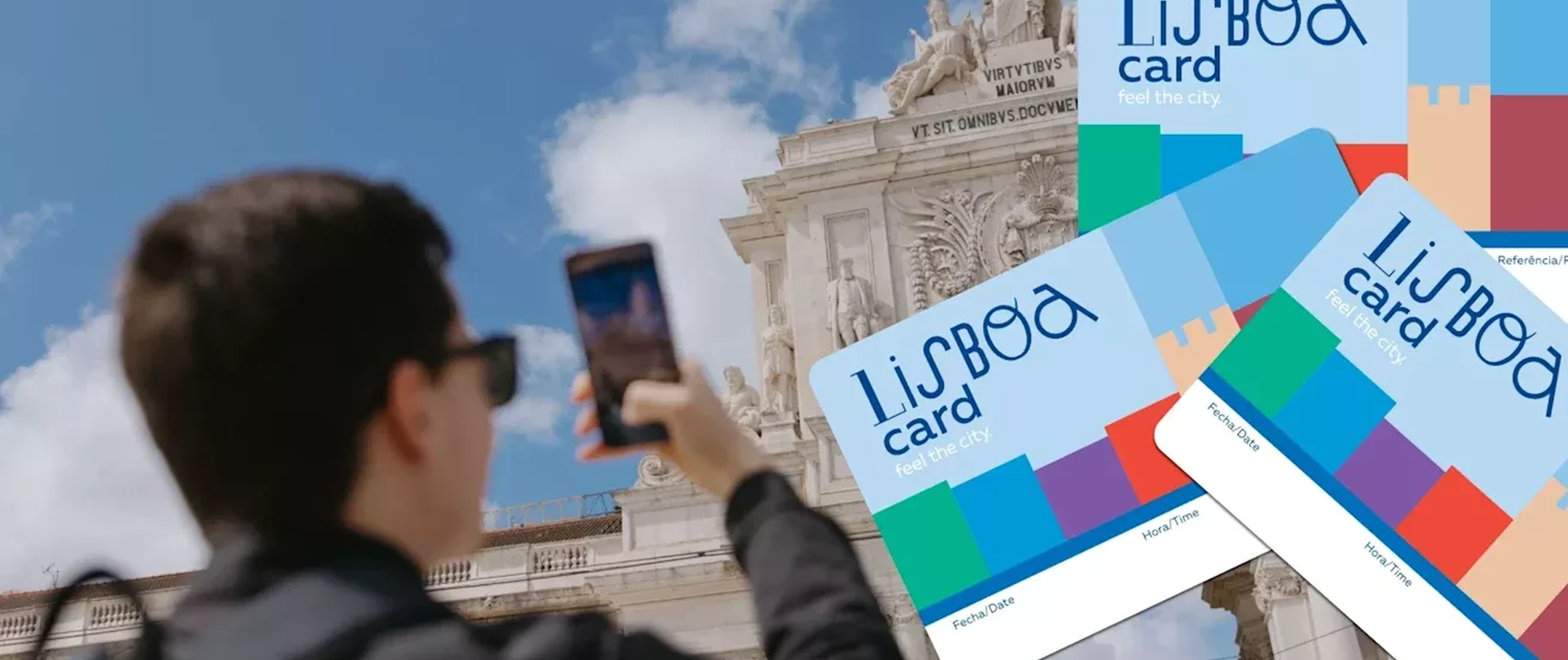 Man taking a photo of the Arco da Rua Augusta with Lisboa Card in the foreground – promoting free access to public transport and top attractions in Lisbon.