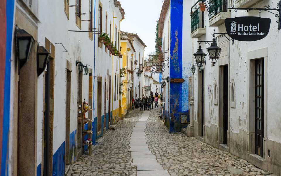 Narrow cobbled street with colorful façades in a medieval atmosphere