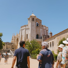 Tour group visiting the Convent of Christ in Tomar, Portugal, with the Charola (Round Church) in view.