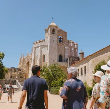 Tour group visiting the Convent of Christ in Tomar, Portugal, with the Charola (Round Church) in view.