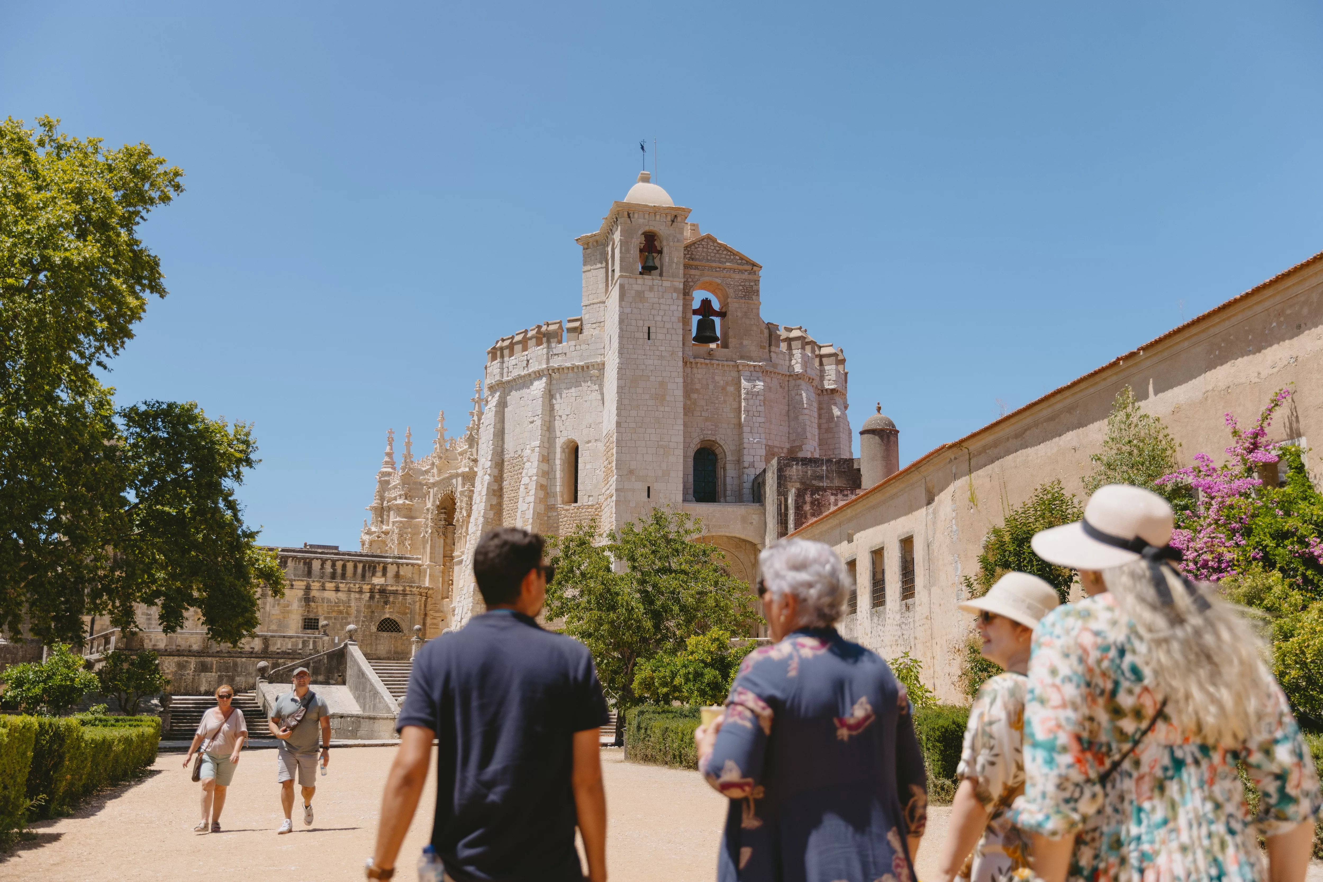 Tour group visiting the Convent of Christ in Tomar, Portugal, with the Charola (Round Church) in view.
