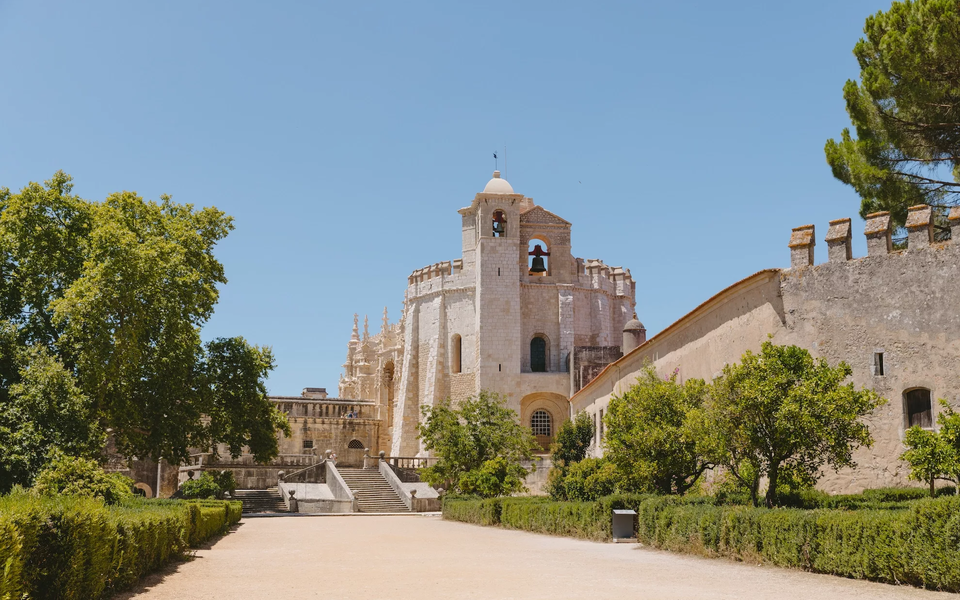 Exterior view of the Convent of Christ in Tomar, Portugal, UNESCO World Heritage site with Manueline architecture.