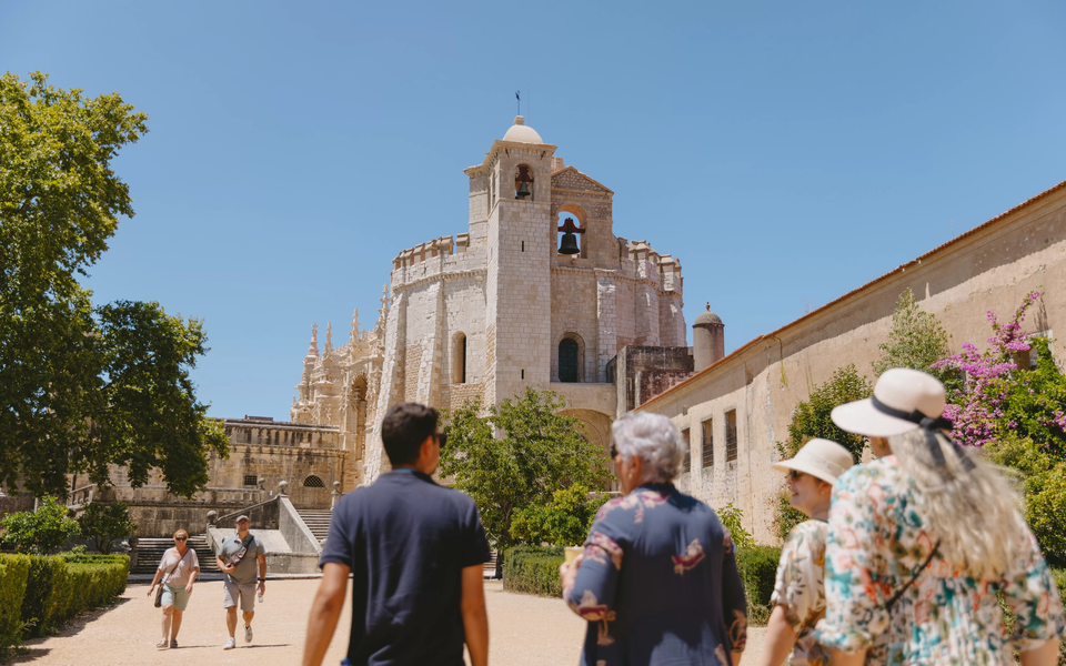 Tour group visiting the Convent of Christ in Tomar, Portugal, with the Charola (Round Church) in view.