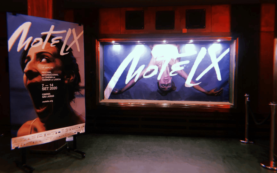 Close-up view of the MOTELX 2020 poster and display at Cinema São Jorge in Lisbon. The poster features a screaming face and announces the 14th edition of the Lisbon International Horror Film Festival, held from 7 to 14 September 2020. The venue is dimly lit, enhancing the eerie ambiance typical of horror-themed events.