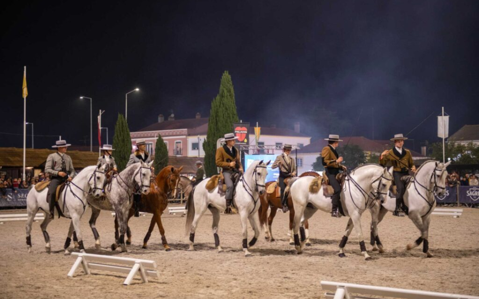 Riders performing a nighttime equestrian show during the National Horse Fair in Golegã