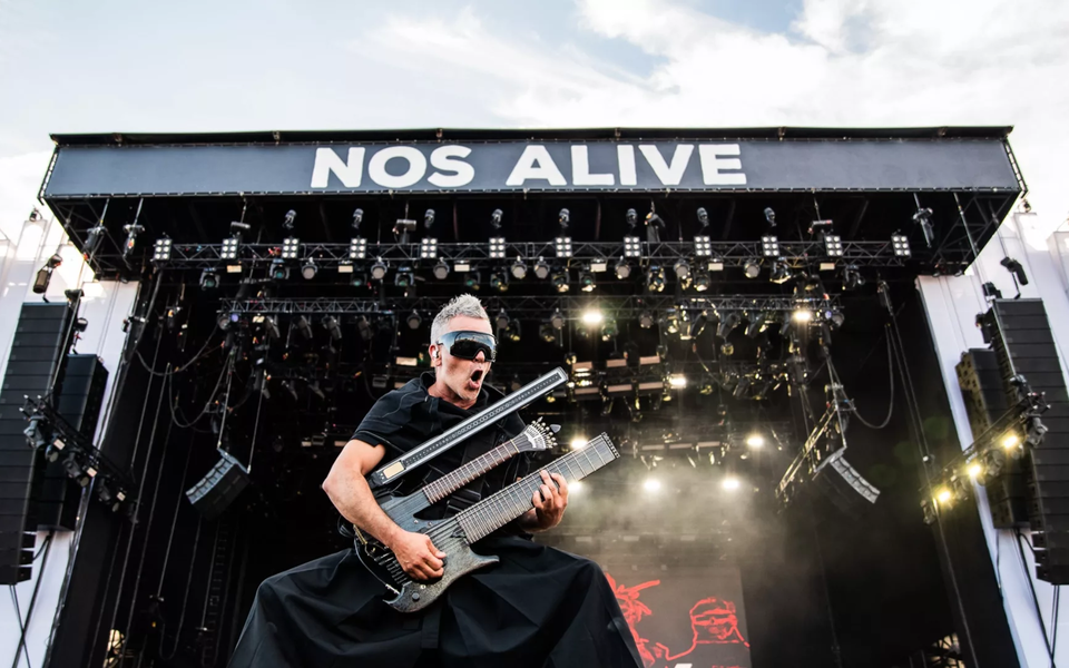 Guitarist performing live on the main stage at NOS Alive music festival in Lisbon, Portugal.