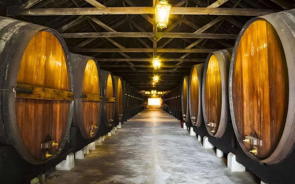 Aging room with giant wooden barrels in a Port wine cellar in Vila Nova de Gaia.