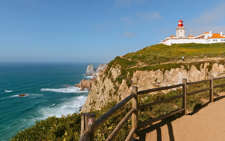 View of the Cabo da Roca lighthouse on a cliff overlooking the Atlantic Ocean, the westernmost point of mainland Europe.