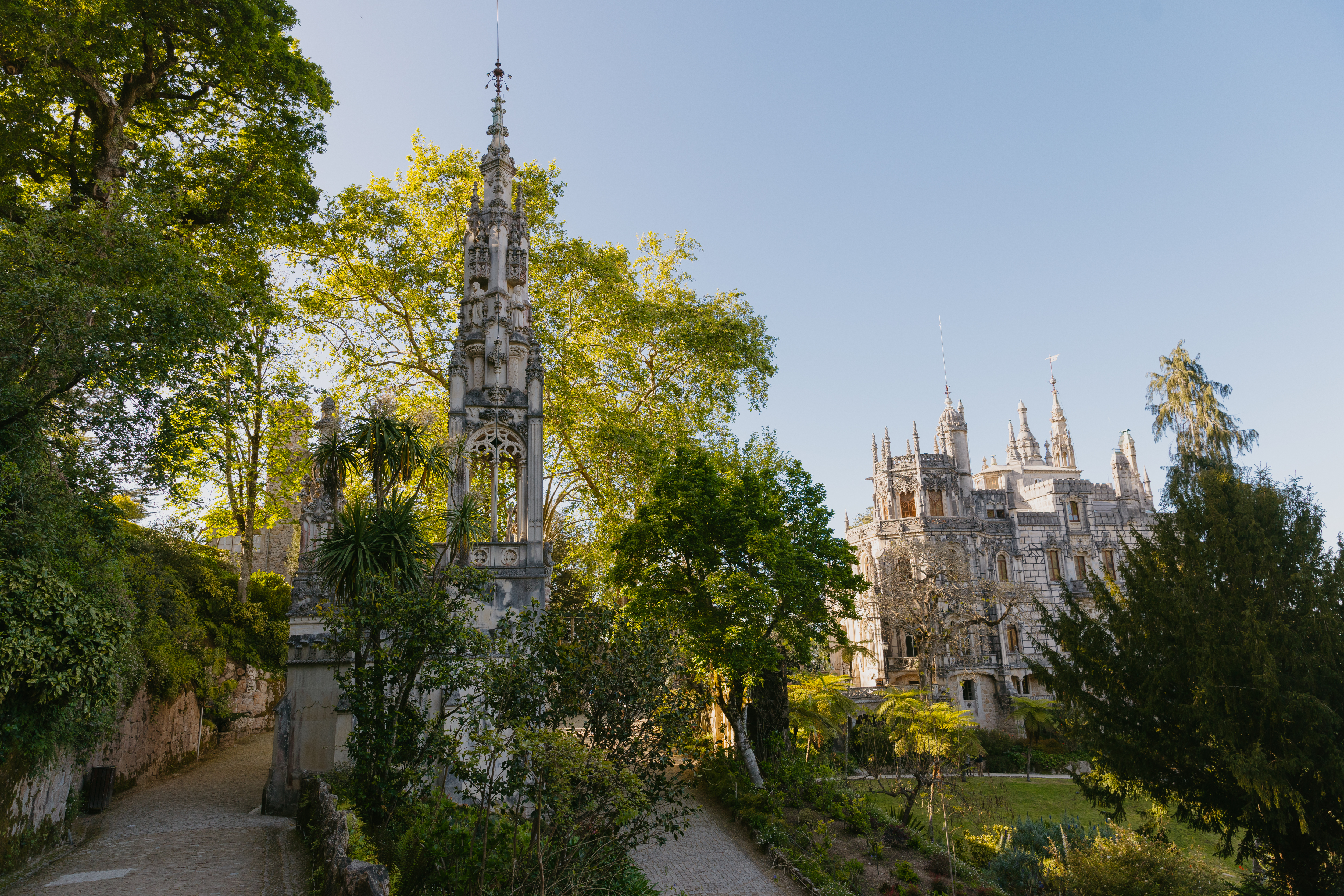 Panoramic view of the palace from the top of the Quinta da Regaleira hill, capturing the elegance of the architecture and landscape.