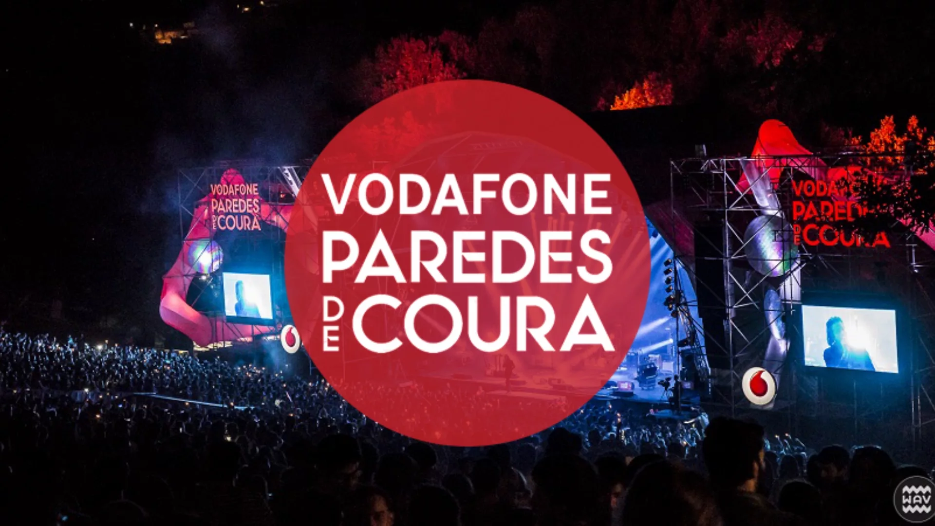 Vodafone Paredes de Coura music festival main stage at night with crowd and red branding in Portugal.