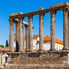 Roman Temple of Évora, also known as Temple of Diana, historic monument in Portugal with classical columns and blue sky.