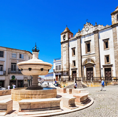 Church of Santo Antão and Henriquina Fountain in Praça do Giraldo, Évora, Portugal.