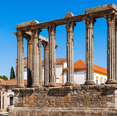 Roman Temple of Évora, also known as Temple of Diana, historic monument in Portugal with classical columns and blue sky.