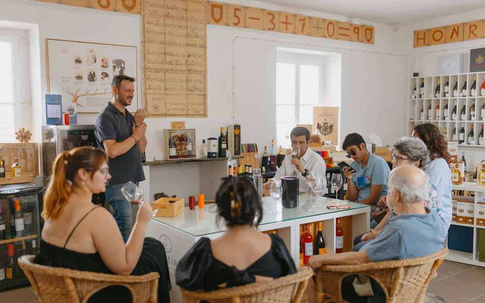 A vibrant wine tasting session held in a historic primary school in Monsaraz, Portugal, featuring exquisite local wines.