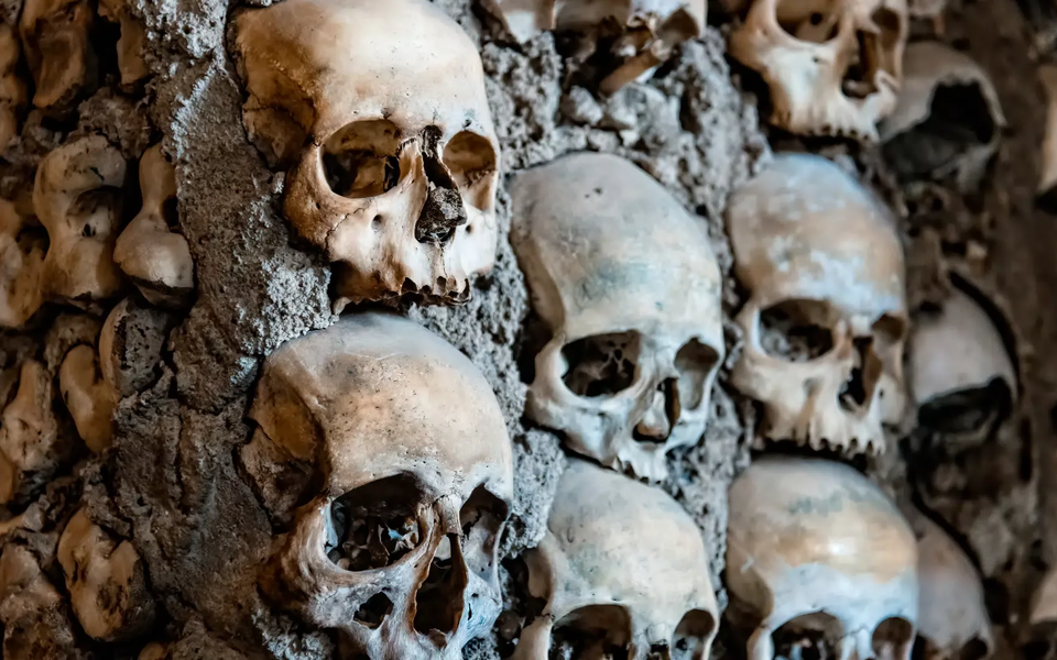 Close-up of human skulls embedded in the walls of the Chapel of Bones, Évora, Portugal.