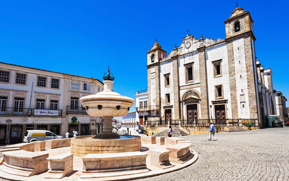 Church of Santo Antão and Henriquina Fountain in Praça do Giraldo, Évora, Portugal.
