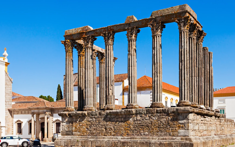 Roman Temple of Évora, also known as Temple of Diana, historic monument in Portugal with classical columns and blue sky.
