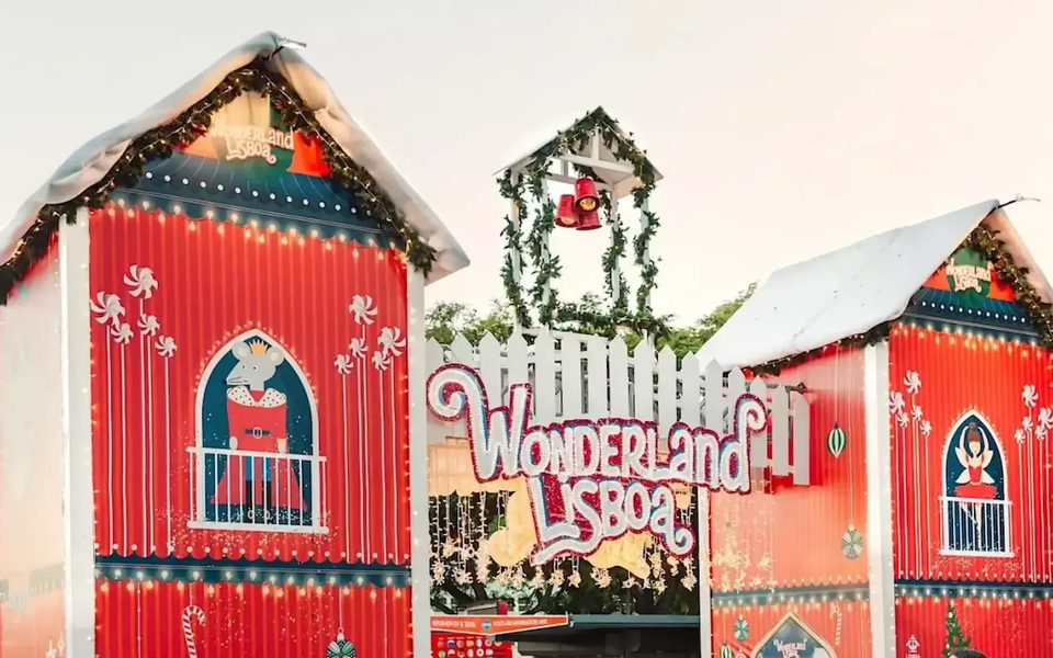 Colorful entrance gate of Wonderland Lisboa with red towers, snow decorations, Christmas lights and cartoon characters